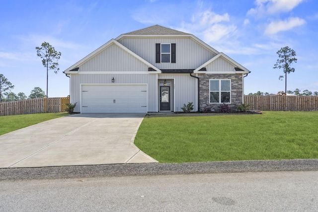 view of front facade featuring fence, driveway, stone siding, and a front lawn