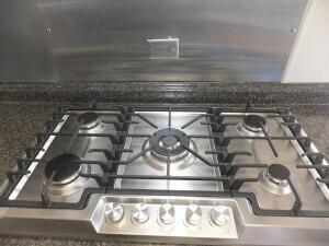 room details featuring backsplash and stainless steel gas stovetop