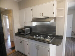 kitchen featuring white cabinets, dark hardwood / wood-style flooring, and stainless steel appliances