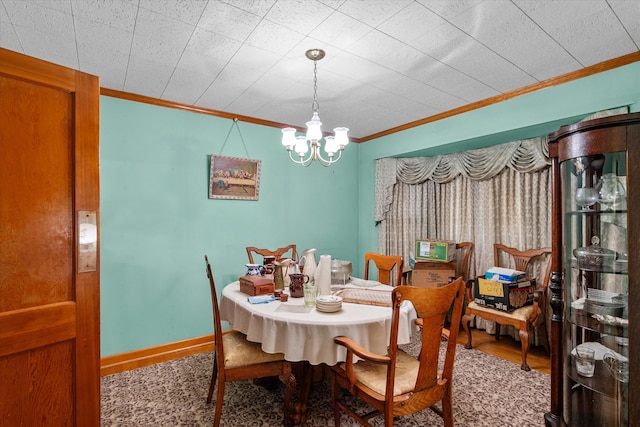 dining room featuring ornamental molding and a chandelier