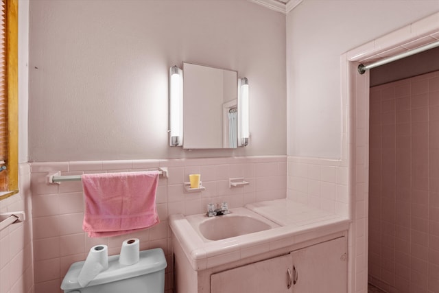 bathroom featuring vanity, toilet, and tile walls