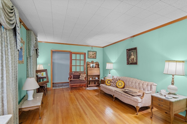 living room with crown molding and light hardwood / wood-style flooring