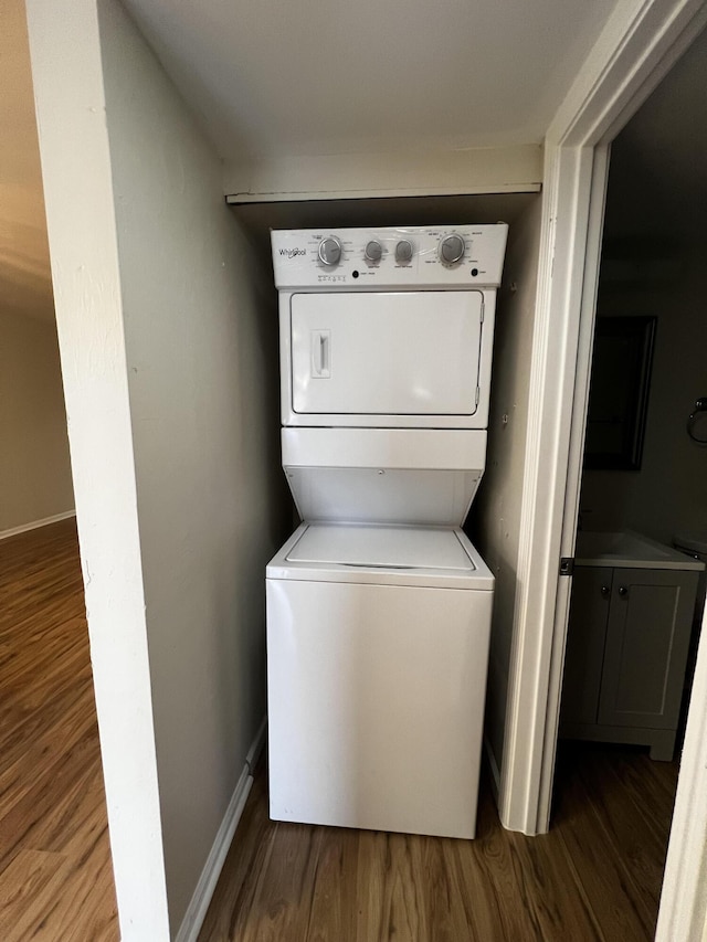 1404 Windsong Cir, Augusta, GA 30907 - laundry area with stacked washing machine and dryer, wood finished floors, and baseboards