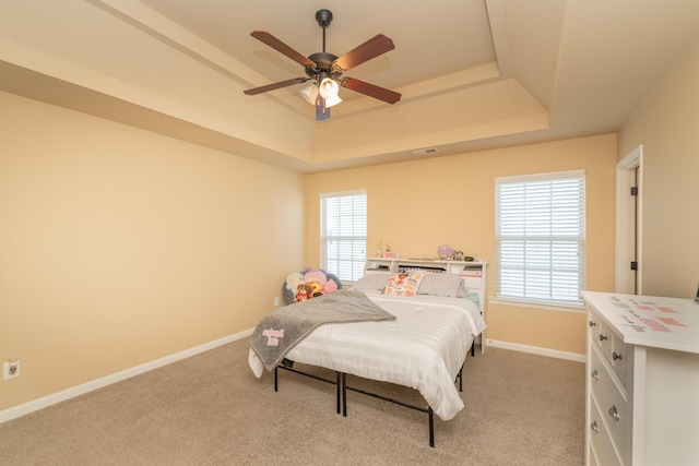 6003 Reynolds Cir, Grovetown, GA 30813 - bedroom featuring a tray ceiling, baseboards, multiple windows, and light carpet