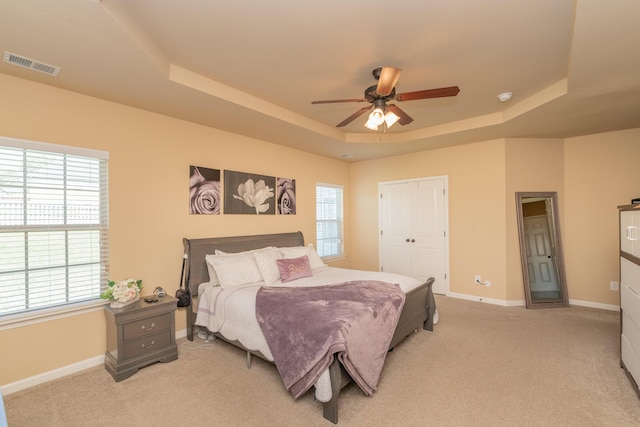 6003 Reynolds Cir, Grovetown, GA 30813 - bedroom featuring light colored carpet, a ceiling fan, visible vents, a raised ceiling, and baseboards