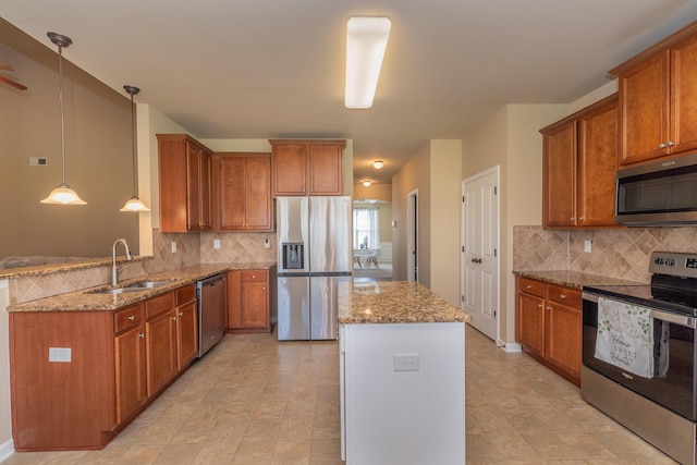 6003 Reynolds Cir, Grovetown, GA 30813 - kitchen with light stone counters, a kitchen island, brown cabinetry, stainless steel appliances, and a sink