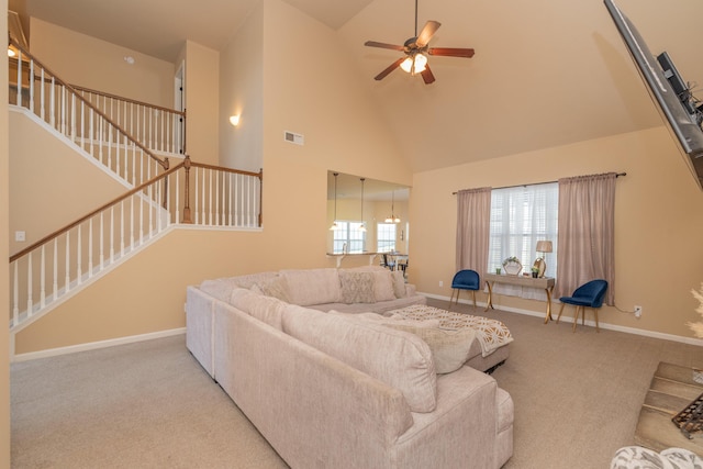 6003 Reynolds Cir, Grovetown, GA 30813 - carpeted living area with baseboards, stairway, visible vents, ceiling fan, and high vaulted ceiling