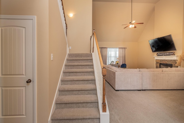 6003 Reynolds Cir, Grovetown, GA 30813 - stairway featuring ceiling fan, a stone fireplace, carpet floors, lofted ceiling, and baseboards