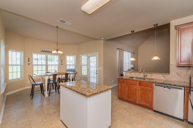 6003 Reynolds Cir, Grovetown, GA 30813 - kitchen with light stone counters, visible vents, brown cabinetry, stainless steel dishwasher, and a sink