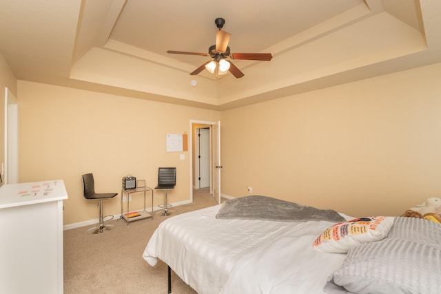 6003 Reynolds Cir, Grovetown, GA 30813 - bedroom with a tray ceiling, baseboards, a ceiling fan, and light carpet