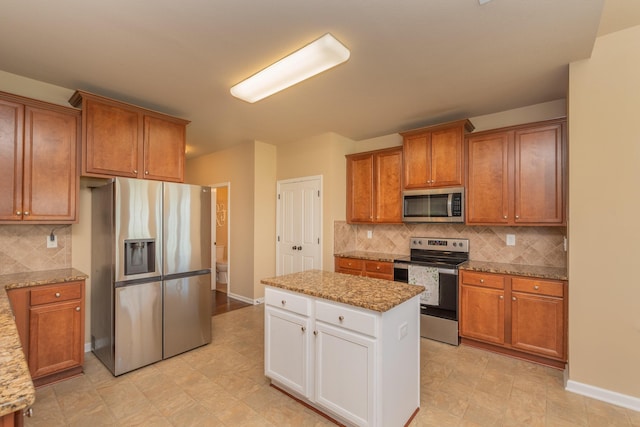 6003 Reynolds Cir, Grovetown, GA 30813 - kitchen featuring brown cabinets, backsplash, light stone countertops, and stainless steel appliances