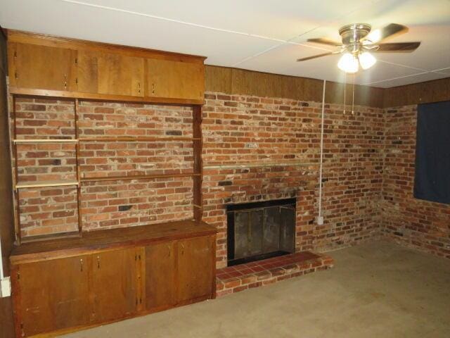 2202 Vireo Dr, North Augusta, SC 29841 - unfurnished living room featuring ceiling fan, a fireplace, and brick wall
