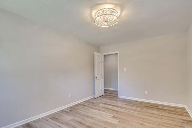 spare room with light wood-type flooring and baseboards