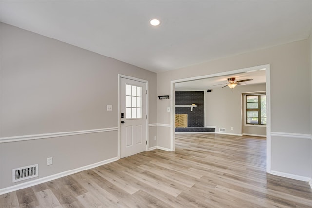 entrance foyer featuring light wood-type flooring, ceiling fan, a fireplace, baseboards, and recessed lighting
