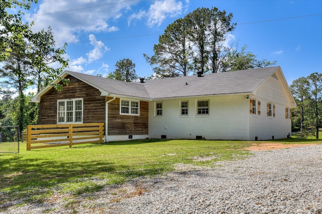 back of property with crawl space, a shingled roof, and brick siding