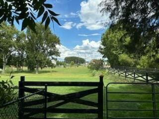 view of gate featuring a yard