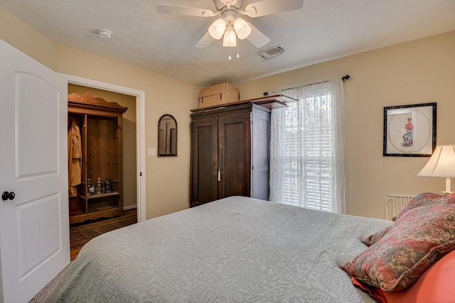 bedroom with visible vents and a ceiling fan