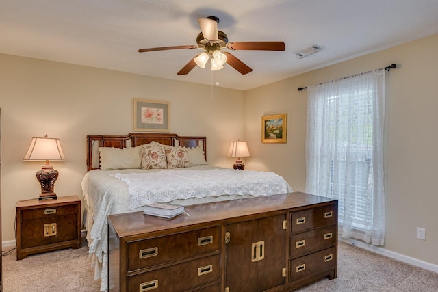 bedroom featuring baseboards, visible vents, a ceiling fan, and light colored carpet