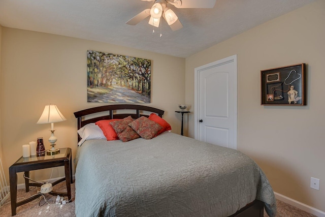 bedroom with a textured ceiling, carpet flooring, a ceiling fan, and baseboards