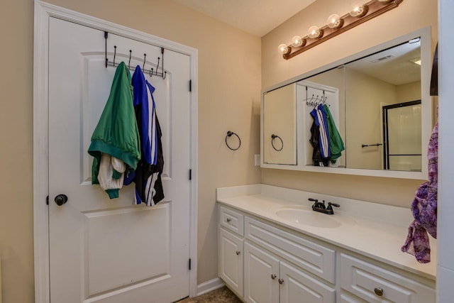 bathroom featuring an enclosed shower and vanity