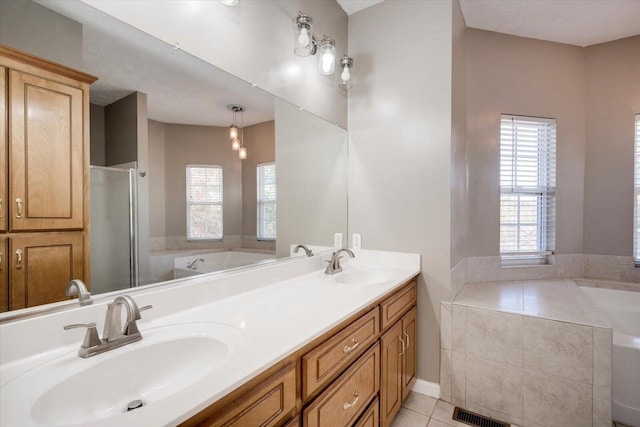 bathroom featuring tile patterned floors, separate shower and tub, and vanity