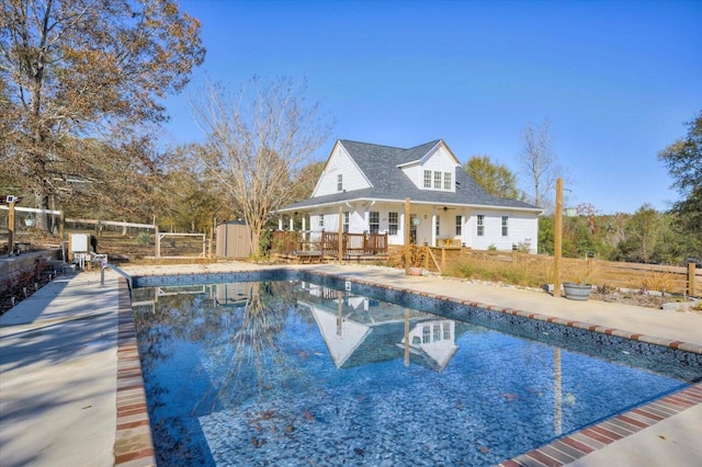 view of pool featuring a shed