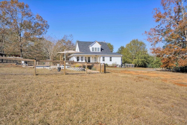 cape cod-style house featuring a front yard