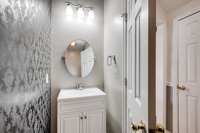 bathroom with vanity and vaulted ceiling