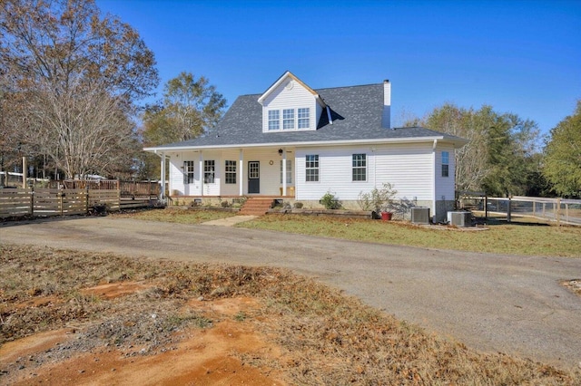 view of front of home with covered porch and central air condition unit