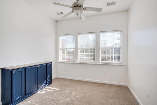 carpeted empty room with ceiling fan