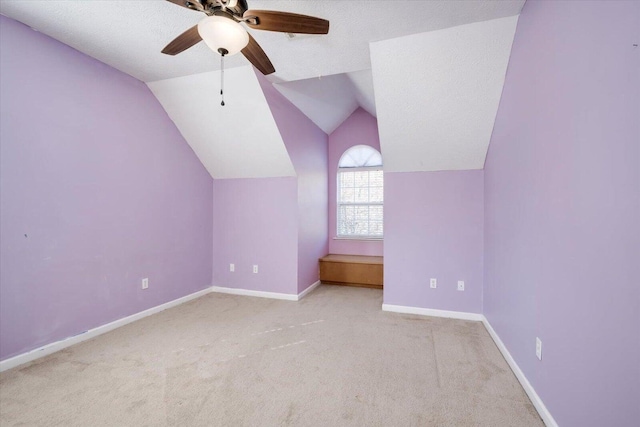 bonus room with ceiling fan, light colored carpet, lofted ceiling, and a textured ceiling