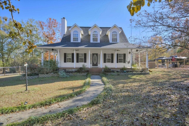 cape cod house with a front yard and covered porch