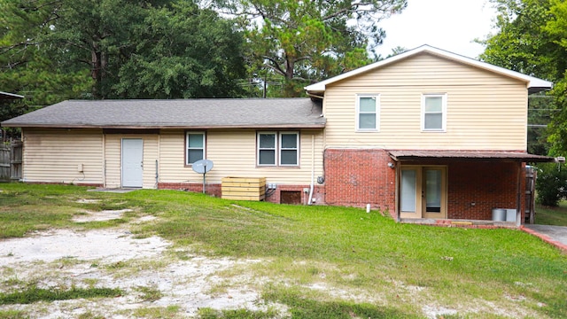 rear view of house with a lawn