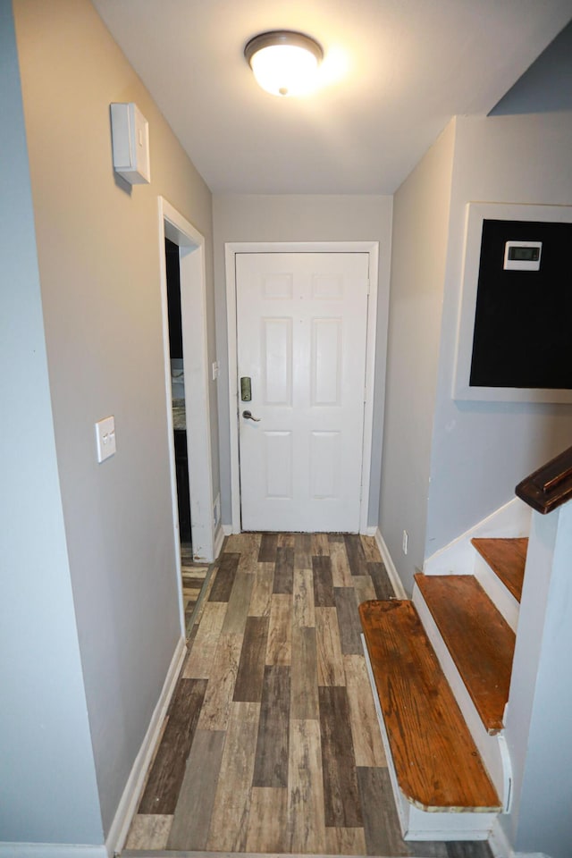 corridor with dark hardwood / wood-style flooring