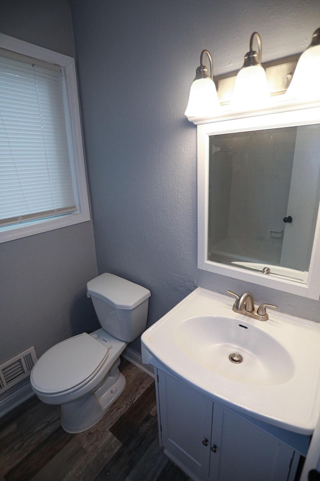 bathroom featuring hardwood / wood-style floors, vanity, and toilet