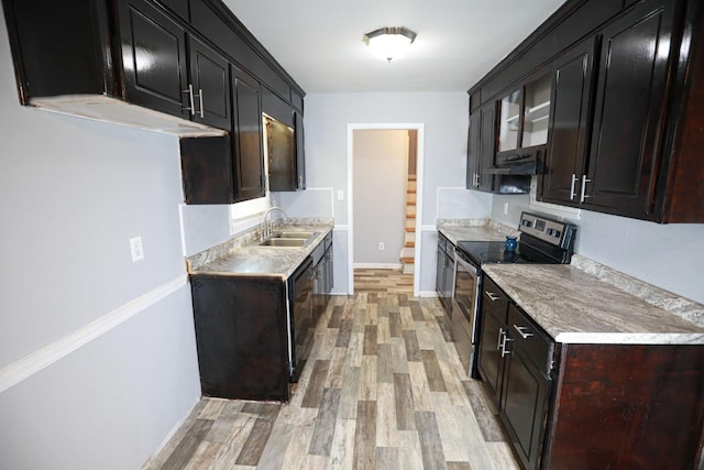 kitchen with dishwasher, sink, light wood-type flooring, and stainless steel range with electric cooktop