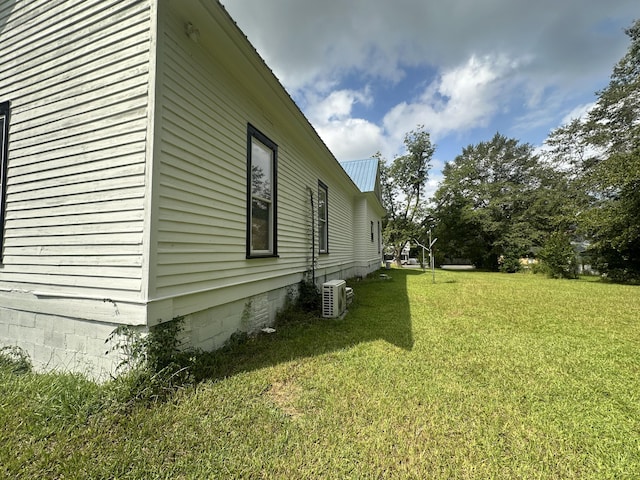 view of home's exterior with a lawn