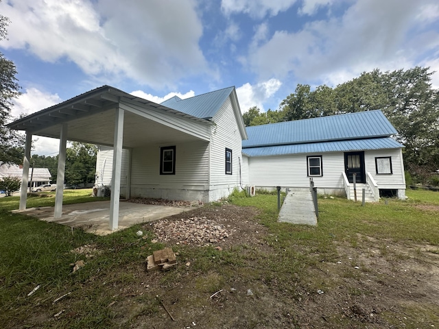 rear view of property featuring a carport