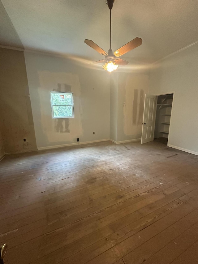 unfurnished bedroom with ceiling fan, crown molding, and hardwood / wood-style flooring