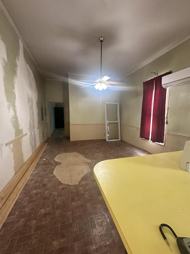 interior space with ceiling fan and ornamental molding