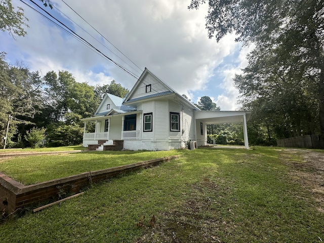 exterior space with a lawn, a carport, covered porch, and cooling unit