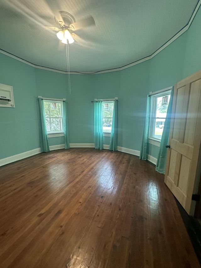 unfurnished room featuring dark hardwood / wood-style floors, an AC wall unit, and ceiling fan