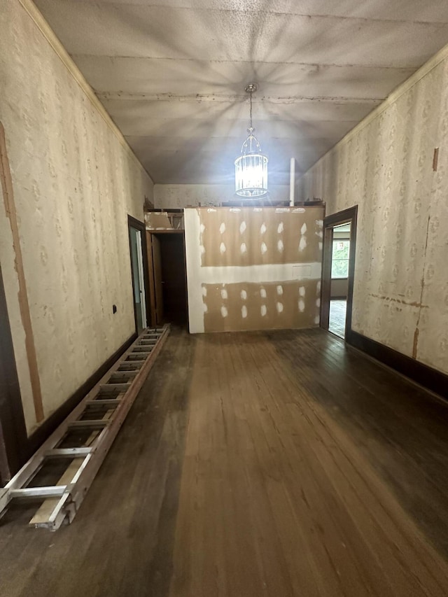 unfurnished room with dark hardwood / wood-style floors and a notable chandelier