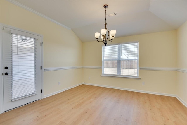 unfurnished room with ornamental molding, lofted ceiling, a chandelier, and light hardwood / wood-style flooring