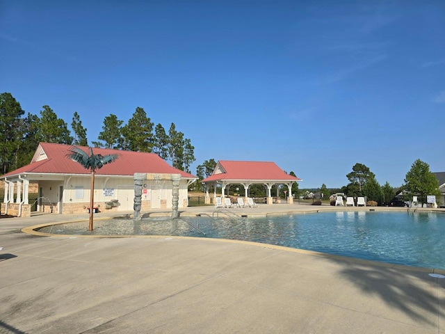 view of swimming pool with a gazebo and a patio area