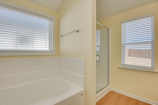 bathroom featuring hardwood / wood-style flooring and independent shower and bath