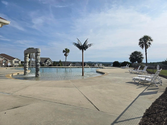 view of swimming pool with pool water feature