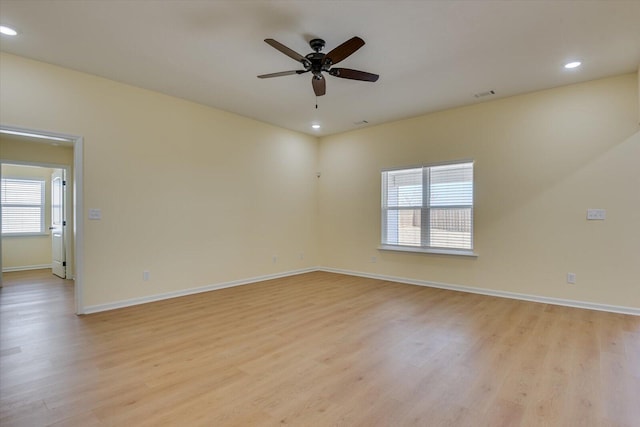 unfurnished room with ceiling fan, a healthy amount of sunlight, and light wood-type flooring