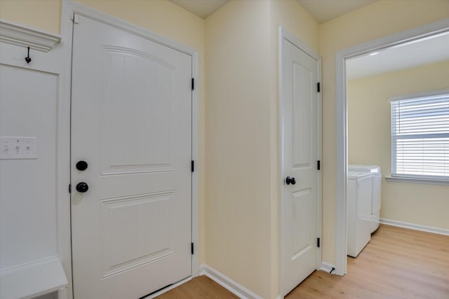 doorway featuring light hardwood / wood-style flooring and washing machine and dryer