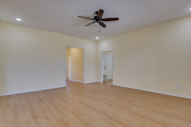 spare room with ceiling fan and light wood-type flooring